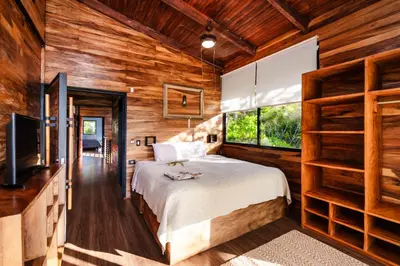 a bedroom with a bed and a large window at Oceanview and Private Pool 8 mins to Downtown in Hernández