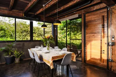 a dining room with a table and chairs at Oceanview and Private Pool 8 mins to Downtown in Hernández