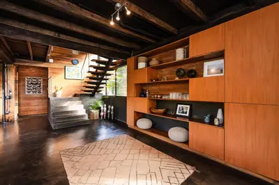 a living room with wooden walls and a staircase at Oceanview and Private Pool 8 mins to Downtown in Hernández