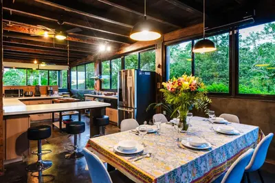a kitchen and dining room with a table and chairs at Oceanview and Private Pool 8 mins to Downtown in Hernández