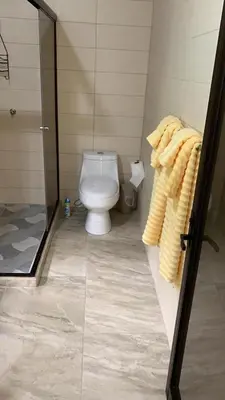 a bathroom with a toilet and a glass shower at Villa Magallanes in San Ramón