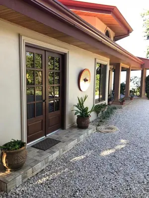 a front door of a house with potted plants at Villa Magallanes in San Ramón