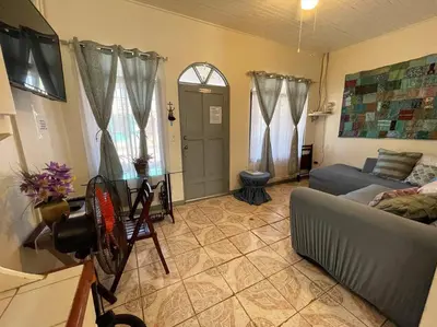 a living room with a couch and a table at Escape to Pier Sands Casita#2- Close to the Beach. in Puntarenas