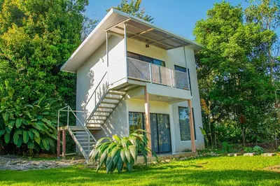 a house with a staircase in front of it at Bella's Country Room in Tanque