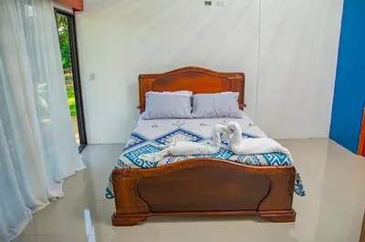 a bedroom with a bed with towels on it at Bella's Country Room in Tanque