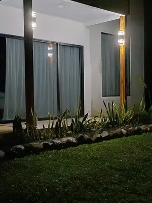 a house with windows with plants in front of it at Bella's Country Room in Tanque
