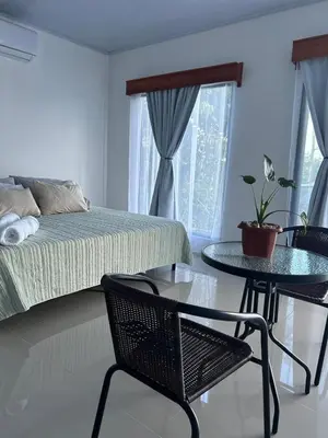 a bedroom with a bed and a table and chairs at Bella's Country Room in Tanque