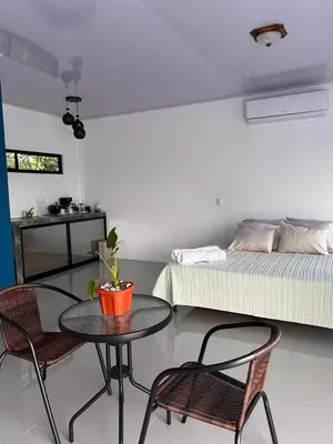 a room with a table and chairs and a bed at Bella's Country Room in Tanque