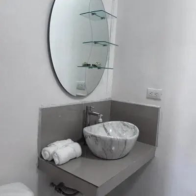 a bathroom with a bowl sink and a mirror at Bella's Country Room in Tanque