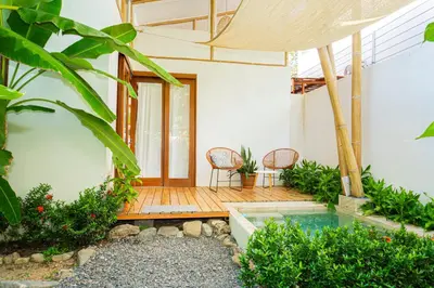 a patio with two chairs and a swimming pool at Casa Serena Private pool 800m from the beach in Uvita