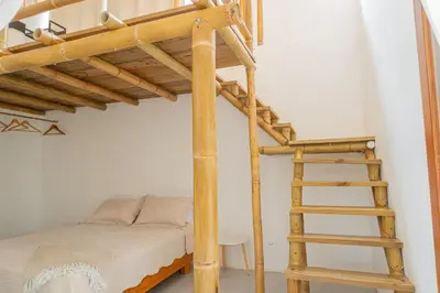 a bedroom with a bunk bed and a wooden ladder at Casa Serena Private pool 800m from the beach in Uvita