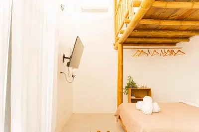 a bedroom with two beds and a wooden ceiling at Casa Serena Private pool 800m from the beach in Uvita