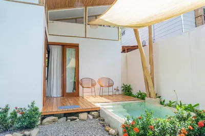 a house with a pool and two chairs on a deck at Casa Serena Private pool 800m from the beach in Uvita