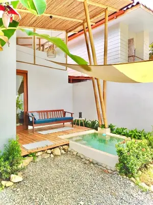 a patio with a bench and a swimming pool at Casa Serena Private pool 800m from the beach in Uvita