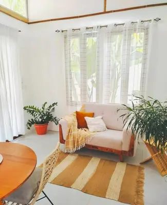 a living room with a couch and a table at Casa Serena Private pool 800m from the beach in Uvita