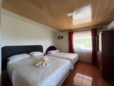 a bedroom with two beds and a window at Casa La Finca Private Pool / AC WiFi 300Mbps in Fortuna