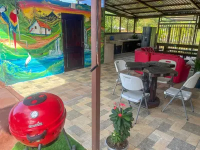 a room with a table and chairs and a painting at Casa La Finca Private Pool / AC WiFi 300Mbps in Fortuna