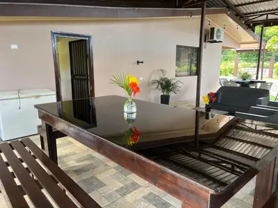 a living room with a table and a couch at Casa La Finca Private Pool / AC WiFi 300Mbps in Fortuna