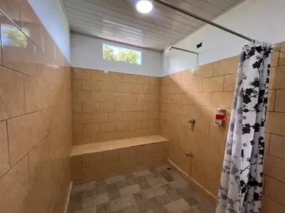 a bathroom with a shower and a shower curtain at Casa La Finca Private Pool / AC WiFi 300Mbps in Fortuna
