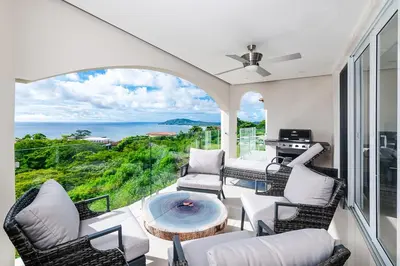 a living room with a view of the ocean at Brand New Ocean View Condo overlooking Tamarindo in Tamarindo
