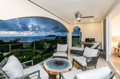 a living room with a view of the ocean at Brand New Ocean View Condo overlooking Tamarindo in Tamarindo