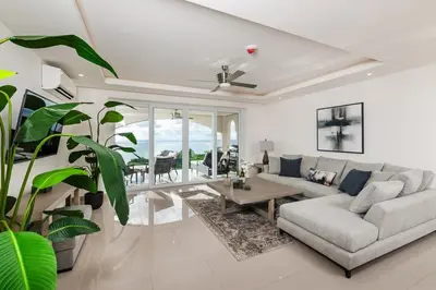 a living room with a couch and a table at Brand New Ocean View Condo overlooking Tamarindo in Tamarindo