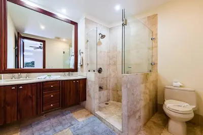 a bathroom with a shower and a toilet and a sink at Beachfront, Sunset, & Ocean Views with Gas Grill in Tamarindo