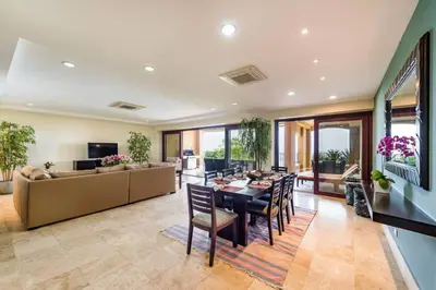 a dining room and living room with a table and chairs at Beachfront, Sunset, & Ocean Views with Gas Grill in Tamarindo