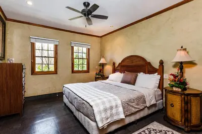a bedroom with a bed and a ceiling fan at Sunset view roof terrace, steps to the beach! in Tamarindo