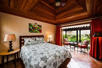 a bedroom with a bed and a table and chairs at Exclusive Beachfront Villa Private Pool, Koi, BBQ in Tamarindo