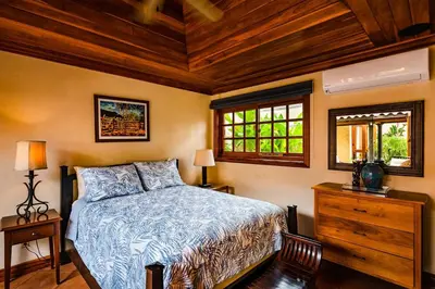 a bedroom with a bed and a wooden ceiling at Exclusive Beachfront Villa Private Pool, Koi, BBQ in Tamarindo