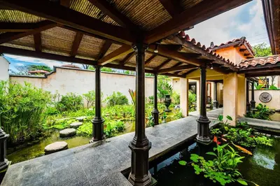 a garden with a koi pond in a house at Exclusive Beachfront Villa Private Pool, Koi, BBQ in Tamarindo