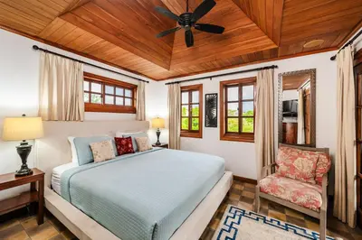 a bedroom with a bed and a ceiling fan at Relaxing Tropical Villa Near the Beach in Tamarindo