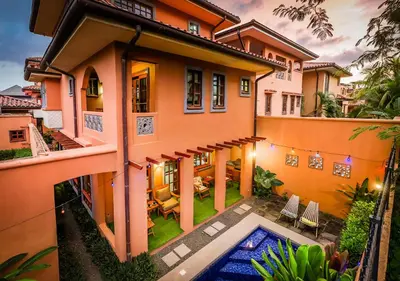 an exterior view of a house with a swimming pool at Relaxing Tropical Villa Near the Beach in Tamarindo