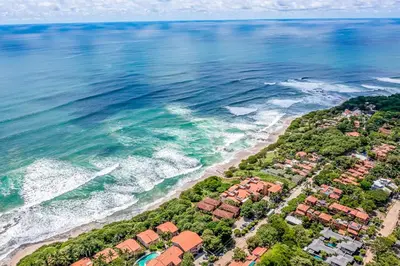 an aerial view of a beach with houses and the ocean at Pool & AC Close to Beach with free bikes! in Tamarindo