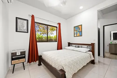 a bedroom with a large bed and a window at Casa Las Mariposas Fantastic Home With Nature Views & Private Pool in Jobos