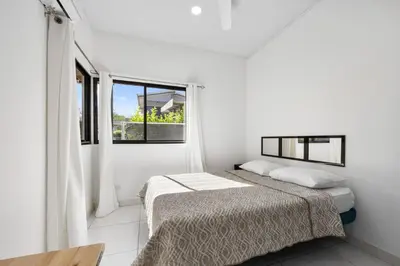 a white room with a bed and a window at Casa Las Mariposas Fantastic Home With Nature Views & Private Pool in Jobos