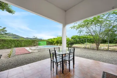 an outdoor patio with a table and chairs and a sink at Casa Las Mariposas Fantastic Home With Nature Views & Private Pool in Jobos
