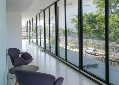 a corridor with chairs and windows in a building at Urban Executive Stay in San José