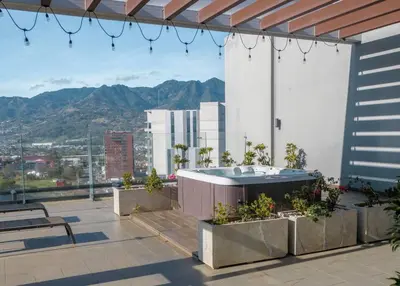 a hot tub on the roof of a building at Urban Executive Stay in San José