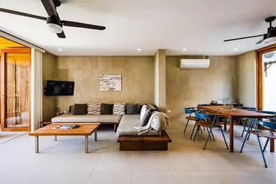 a living room with a couch and a table at Spacious & serene with partial ocean & jungle view in Tamarindo