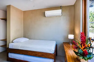 a bedroom with a bed and a air conditioner at Spacious & serene with partial ocean & jungle view in Tamarindo