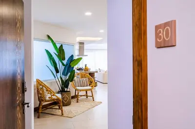 a hallway with chairs and a plant in a room at Amazing New Peninsula Penthouse with Ocean Views in Tamarindo