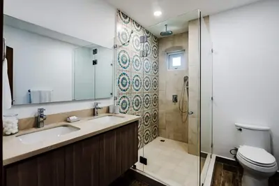 a bathroom with a toilet and a sink and a shower at Amazing New Peninsula Penthouse with Ocean Views in Tamarindo
