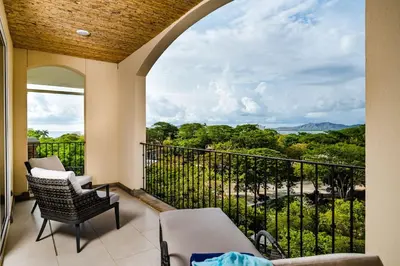 a balcony with a view of the mountains at Amazing New Peninsula Penthouse with Ocean Views in Tamarindo