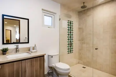 a bathroom with a toilet and a sink and a shower at Amazing New Peninsula Penthouse with Ocean Views in Tamarindo