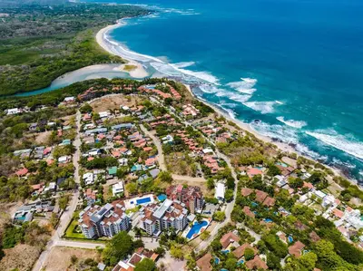 an aerial view of a residential estate next to the ocean at Amazing New Peninsula Penthouse with Ocean Views in Tamarindo