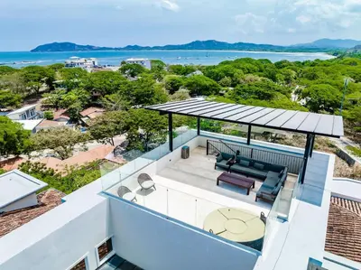 a view of the ocean from the balcony of a house at Amazing New Peninsula Penthouse with Ocean Views in Tamarindo