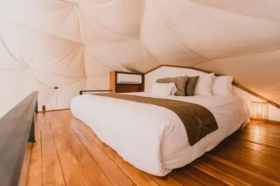 a bedroom with a bed in a tent at Ananta Forest - Sunset & Gulf View - Glamping Dome and Mountain House in Monteverde Costa Rica