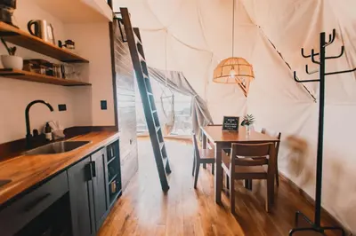 a dining room with a table in a tent at Ananta Forest - Sunset & Gulf View - Glamping Dome and Mountain House in Monteverde Costa Rica